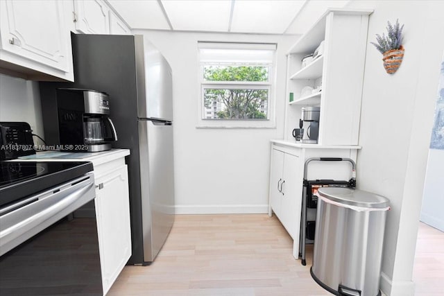 1501 S Ocean Blvd Unit 227, Lauderdale By The Sea, FL 33062 - kitchen with electric range, white cabinets, light wood finished floors, open shelves, and light countertops