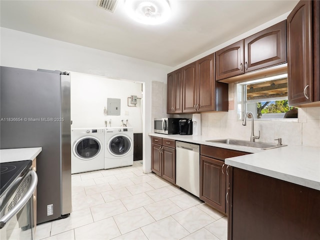 6530 Tyler St, Hollywood, FL 33024 - kitchen featuring stainless steel appliances, washer and dryer, light countertops, and electric panel