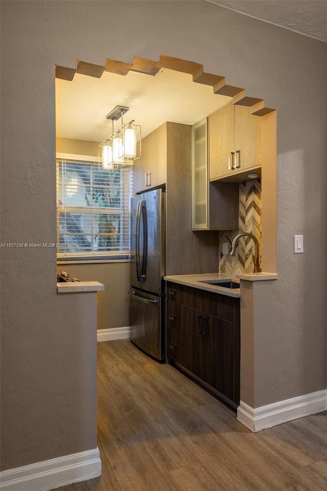 1611 Euclid Ave Unit 5, Miami Beach, FL 33139 - kitchen with freestanding refrigerator, dark wood finished floors, light countertops, a chandelier, and tasteful backsplash