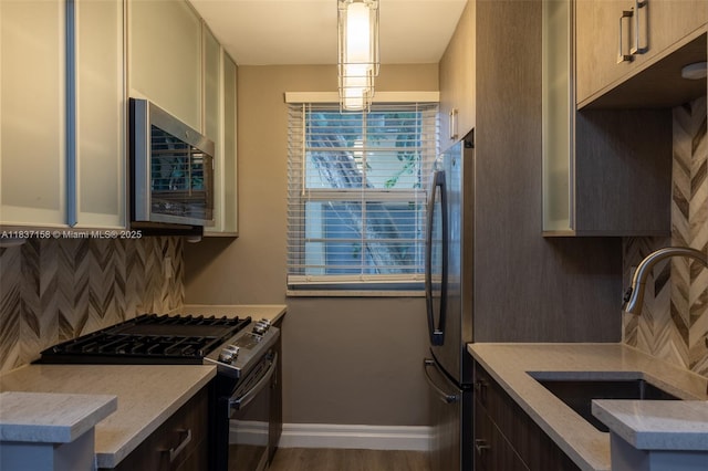 1611 Euclid Ave Unit 5, Miami Beach, FL 33139 - kitchen featuring stainless steel appliances, tasteful backsplash, decorative light fixtures, and wood finished floors