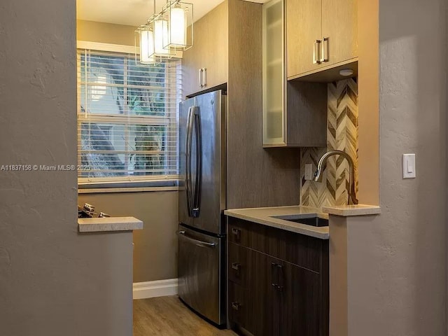 1611 Euclid Ave Unit 5, Miami Beach, FL 33139 - kitchen featuring freestanding refrigerator, light countertops, a textured wall, light wood-type flooring, and hanging light fixtures