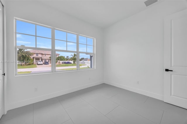 121 SW Sea Lion Rd, Port St Lucie, FL 34953 - tiled empty room with baseboards