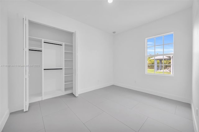 121 SW Sea Lion Rd, Port St Lucie, FL 34953 - unfurnished bedroom featuring a closet, recessed lighting, and tile patterned flooring