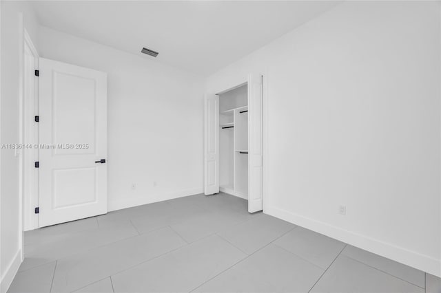 121 SW Sea Lion Rd, Port St Lucie, FL 34953 - unfurnished bedroom with tile patterned floors and a closet