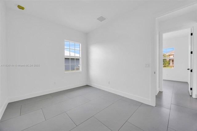 121 SW Sea Lion Rd, Port St Lucie, FL 34953 - empty room featuring plenty of natural light and tile patterned floors