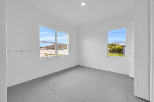 121 SW Sea Lion Rd, Port St Lucie, FL 34953 - tiled spare room with healthy amount of natural light and recessed lighting