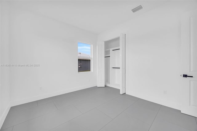 121 SW Sea Lion Rd, Port St Lucie, FL 34953 - unfurnished room featuring baseboards and dark tile patterned flooring
