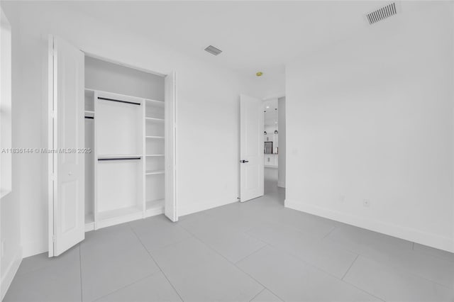 121 SW Sea Lion Rd, Port St Lucie, FL 34953 - unfurnished bedroom with a closet and tile patterned floors
