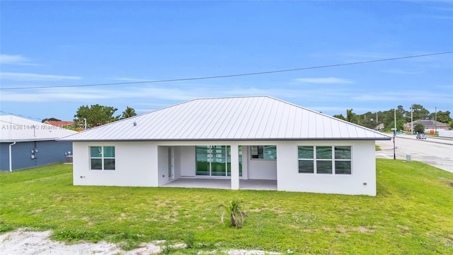 121 SW Sea Lion Rd, Port St Lucie, FL 34953 - rear view of property featuring stucco siding, a patio area, and a yard