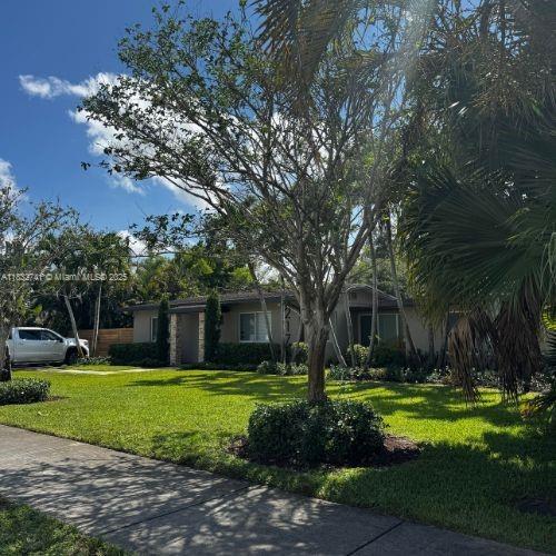 217 E Acre Dr, Plantation, FL 33317 - obstructed view of property with a front yard