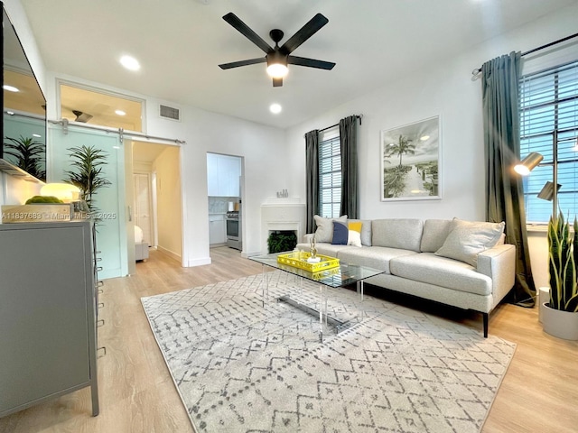 936 Pennsylvania Ave Unit 101, Miami Beach, FL 33139 - living area with a barn door, a ceiling fan, light wood-style floors, and recessed lighting