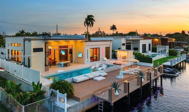 2225 NE 19th St, Fort Lauderdale, FL 33305 - back of property with an outdoor pool, a patio area, and stucco siding
