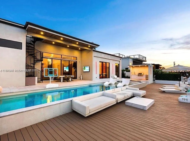 2225 NE 19th St, Fort Lauderdale, FL 33305 - rear view of property with stairway, a wooden deck, stucco siding, and an outdoor pool