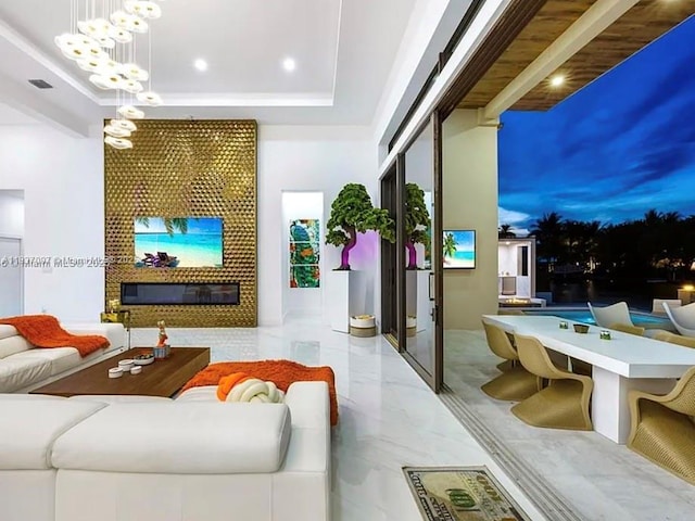 2225 NE 19th St, Fort Lauderdale, FL 33305 - living room featuring a glass covered fireplace, marble finish floors, a chandelier, recessed lighting, and a raised ceiling
