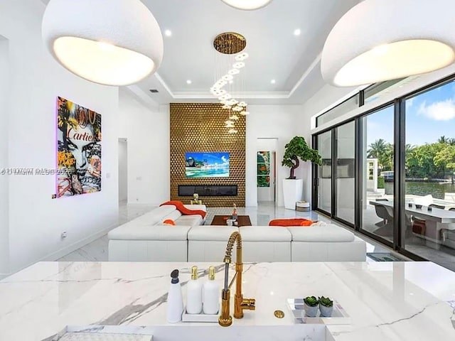 2225 NE 19th St, Fort Lauderdale, FL 33305 - living area featuring a tray ceiling, marble tiled floors, a towering ceiling, and recessed lighting