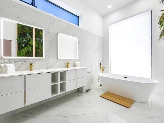 2225 NE 19th St, Fort Lauderdale, FL 33305 - full bathroom featuring double vanity, marble tiled flooring, a freestanding bath, and recessed lighting