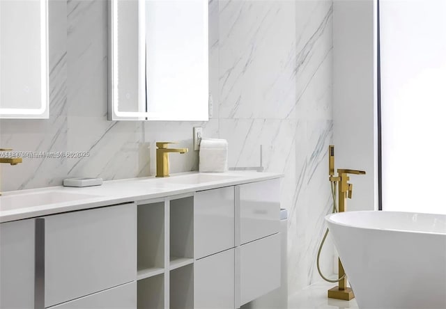 2225 NE 19th St, Fort Lauderdale, FL 33305 - bathroom with double vanity, tile walls, tasteful backsplash, and a soaking tub