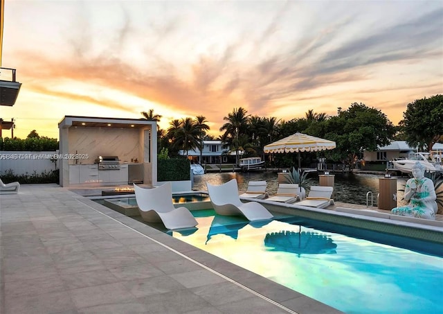 2225 NE 19th St, Fort Lauderdale, FL 33305 - outdoor pool featuring exterior kitchen, a patio, a boat dock, and a water view
