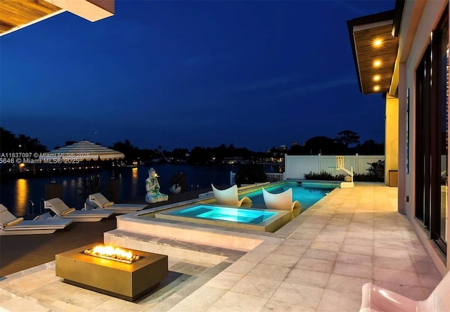 2225 NE 19th St, Fort Lauderdale, FL 33305 - pool at twilight with a fire pit, a patio, a water view, and an in-ground hot tub