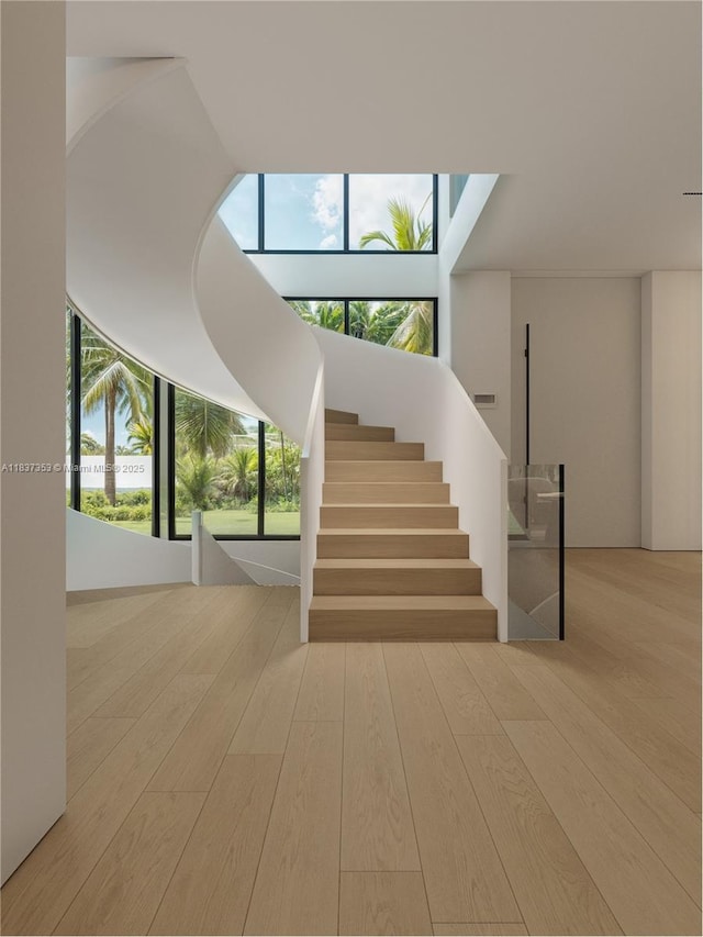 1661 Onaway Dr, Miami, FL 33133 - stairway featuring wood finished floors and plenty of natural light