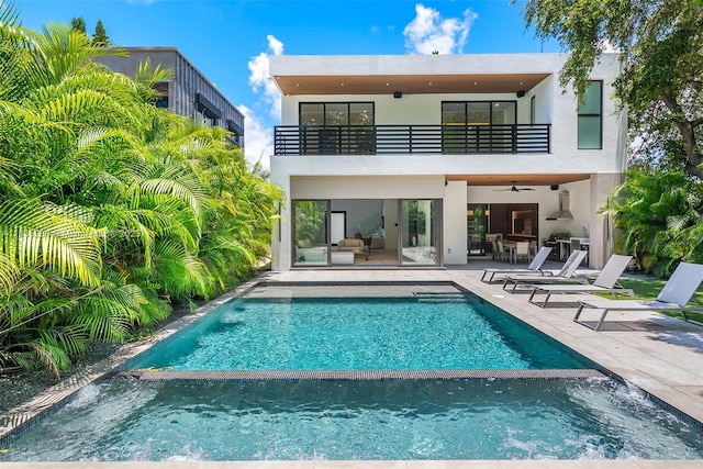 260 NW 47th St, Miami, FL 33127 - rear view of house with a balcony, a ceiling fan, a pool with connected hot tub, and a patio area