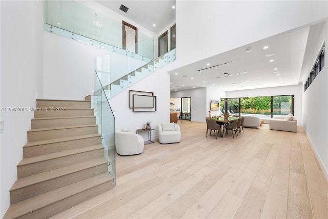 260 NW 47th St, Miami, FL 33127 - stairway featuring wood-type flooring, a ceiling fan, recessed lighting, and a high ceiling