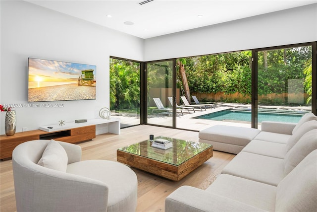 260 NW 47th St, Miami, FL 33127 - living area featuring healthy amount of natural light, wood finished floors, and recessed lighting