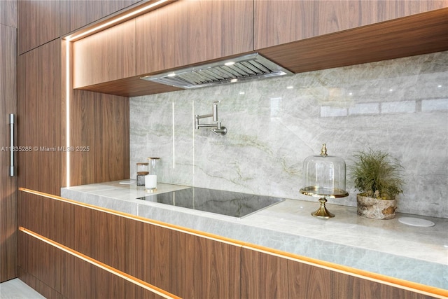 260 NW 47th St, Miami, FL 33127 - kitchen featuring black electric stovetop, custom exhaust hood, and light countertops