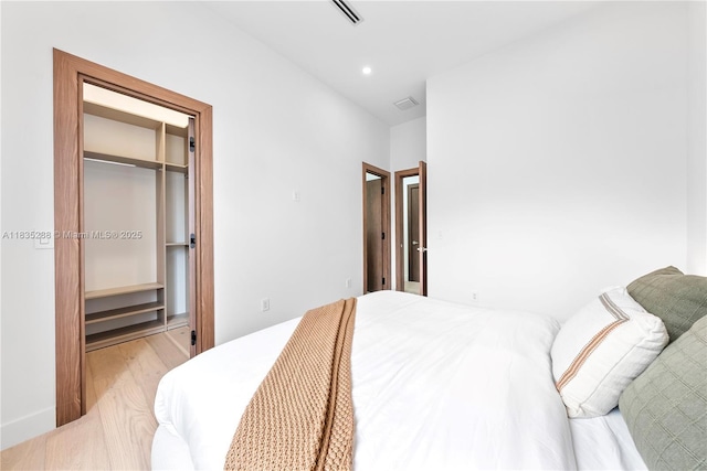 260 NW 47th St, Miami, FL 33127 - bedroom with a walk in closet, wood finished floors, and recessed lighting