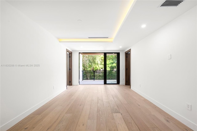 260 NW 47th St, Miami, FL 33127 - empty room featuring light wood-type flooring, recessed lighting, and a raised ceiling