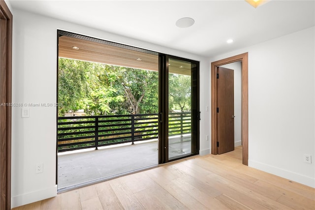 260 NW 47th St, Miami, FL 33127 - doorway with wood finished floors, healthy amount of natural light, and recessed lighting