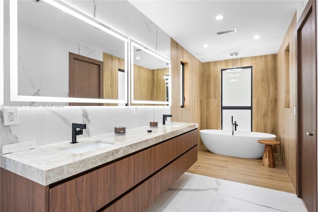 260 NW 47th St, Miami, FL 33127 - full bathroom featuring double vanity, a freestanding bath, recessed lighting, and marble finish flooring