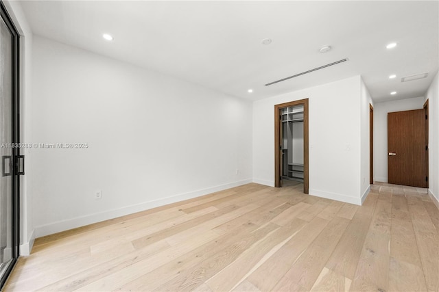 260 NW 47th St, Miami, FL 33127 - empty room with light wood-style floors, recessed lighting, and a smoke detector