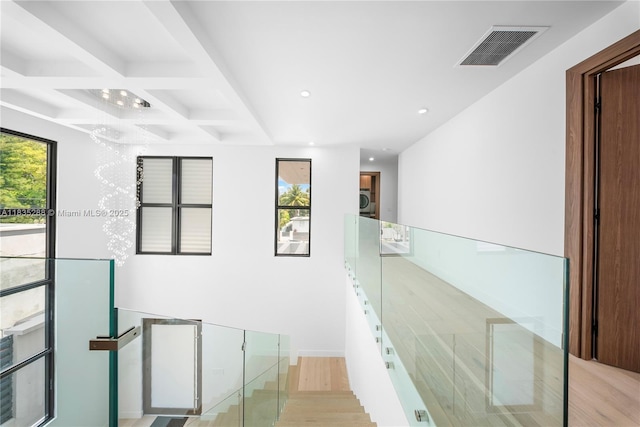 260 NW 47th St, Miami, FL 33127 - staircase featuring coffered ceiling, wood finished floors, recessed lighting, and beam ceiling
