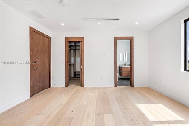 260 NW 47th St, Miami, FL 33127 - unfurnished bedroom featuring light wood finished floors, recessed lighting, a walk in closet, and connected bathroom