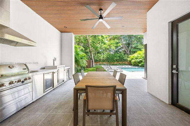260 NW 47th St, Miami, FL 33127 - view of patio with an outdoor kitchen, ceiling fan, an outdoor pool, and outdoor dining area