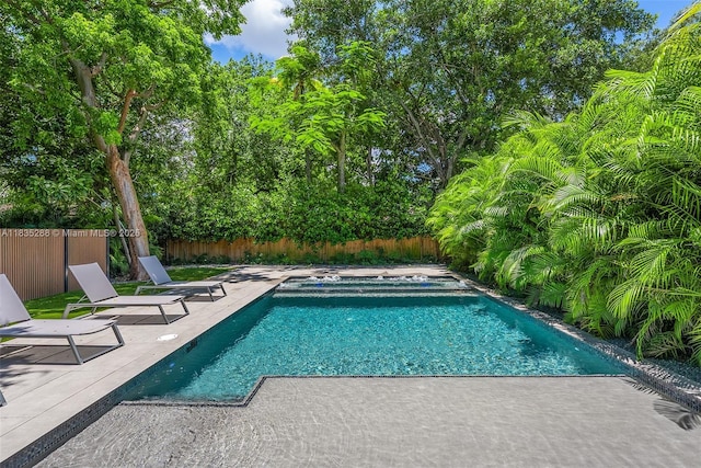 260 NW 47th St, Miami, FL 33127 - view of swimming pool featuring a fenced backyard, a patio area, and an in-ground hot tub
