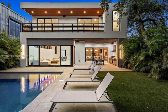 260 NW 47th St, Miami, FL 33127 - back of house with a balcony, ceiling fan, a patio, an outdoor living space, and stucco siding