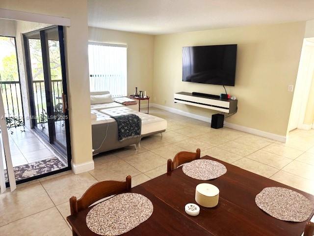 3817 Cocoplum Cir Unit 3585, Coconut Creek, FL 33063 - tiled living area with healthy amount of natural light