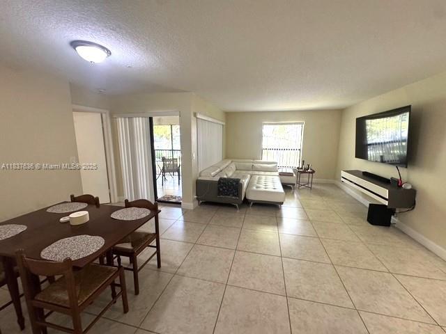 3817 Cocoplum Cir Unit 3585, Coconut Creek, FL 33063 - living room with a textured ceiling and light tile patterned floors