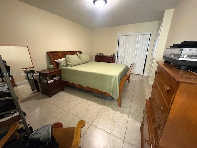 3817 Cocoplum Cir Unit 3585, Coconut Creek, FL 33063 - bedroom with light tile patterned floors and a textured ceiling