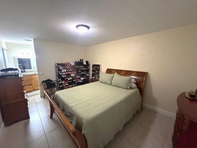 3817 Cocoplum Cir Unit 3585, Coconut Creek, FL 33063 - bedroom featuring light tile patterned flooring and a textured ceiling