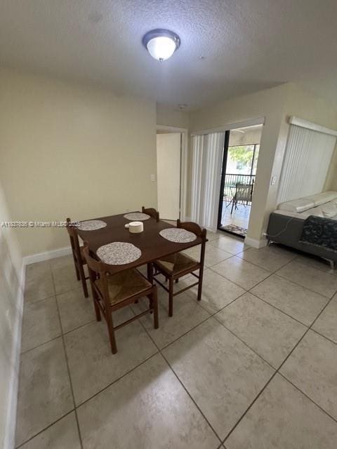 3817 Cocoplum Cir Unit 3585, Coconut Creek, FL 33063 - dining space with a textured ceiling and light tile patterned floors