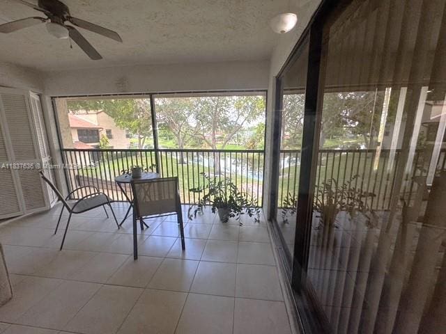 3817 Cocoplum Cir Unit 3585, Coconut Creek, FL 33063 - sunroom featuring ceiling fan and a water view