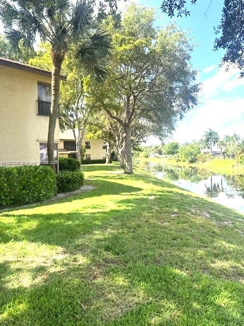3817 Cocoplum Cir Unit 3585, Coconut Creek, FL 33063 - view of grassy yard featuring a water view