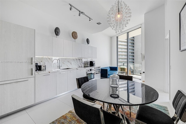 501 NE 31st St Unit 4007, Miami, FL 33137 - dining room featuring a chandelier, track lighting, and light tile patterned floors