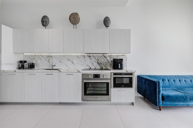 501 NE 31st St Unit 4007, Miami, FL 33137 - kitchen with stainless steel oven, light countertops, and backsplash