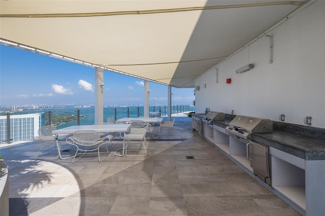 501 NE 31st St Unit 4007, Miami, FL 33137 - view of patio with outdoor dining space, exterior kitchen, and a water view