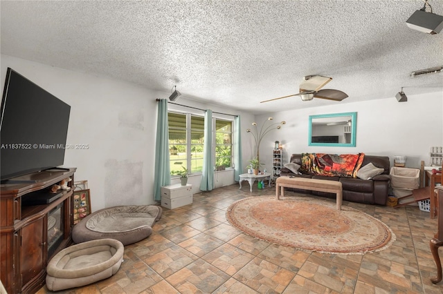 17041 Tarpon Way, Fort Myers, FL 33917 - living area featuring stone finish flooring, a textured ceiling, ceiling fan, and a wood stove