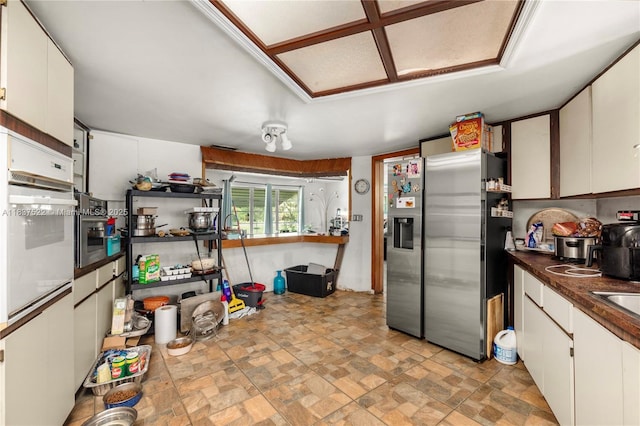 17041 Tarpon Way, Fort Myers, FL 33917 - kitchen featuring stainless steel fridge with ice dispenser, white cabinetry, white oven, and dark countertops